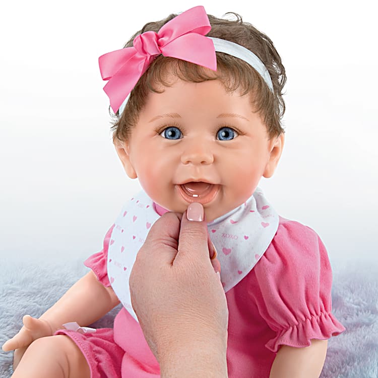 Hand Painted Realistic Baby Doll Featuring A Ruffled Pink Bubble Outfit With Matching Headband Bib