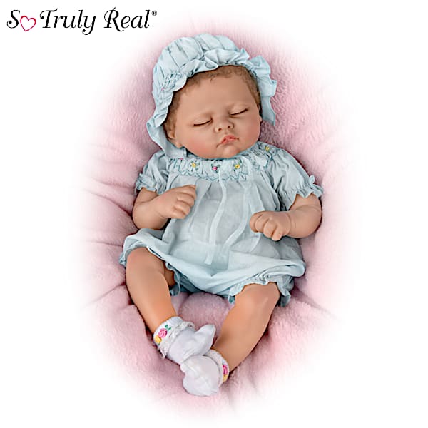 Sleeping Realistic Baby Doll Featuring A Blue Romper With Smocked Floral Details And Matching Bonnet